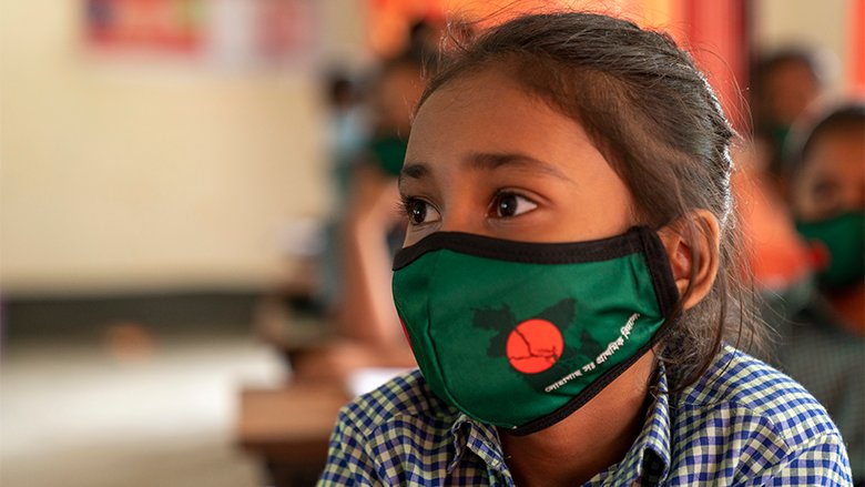 School girl in Bangladesh wearing a mask while attending classes during and after the COVID-19 pandemic.