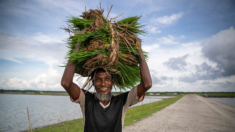 Farmer in front of a Coastal Embankment in Bangladesh
