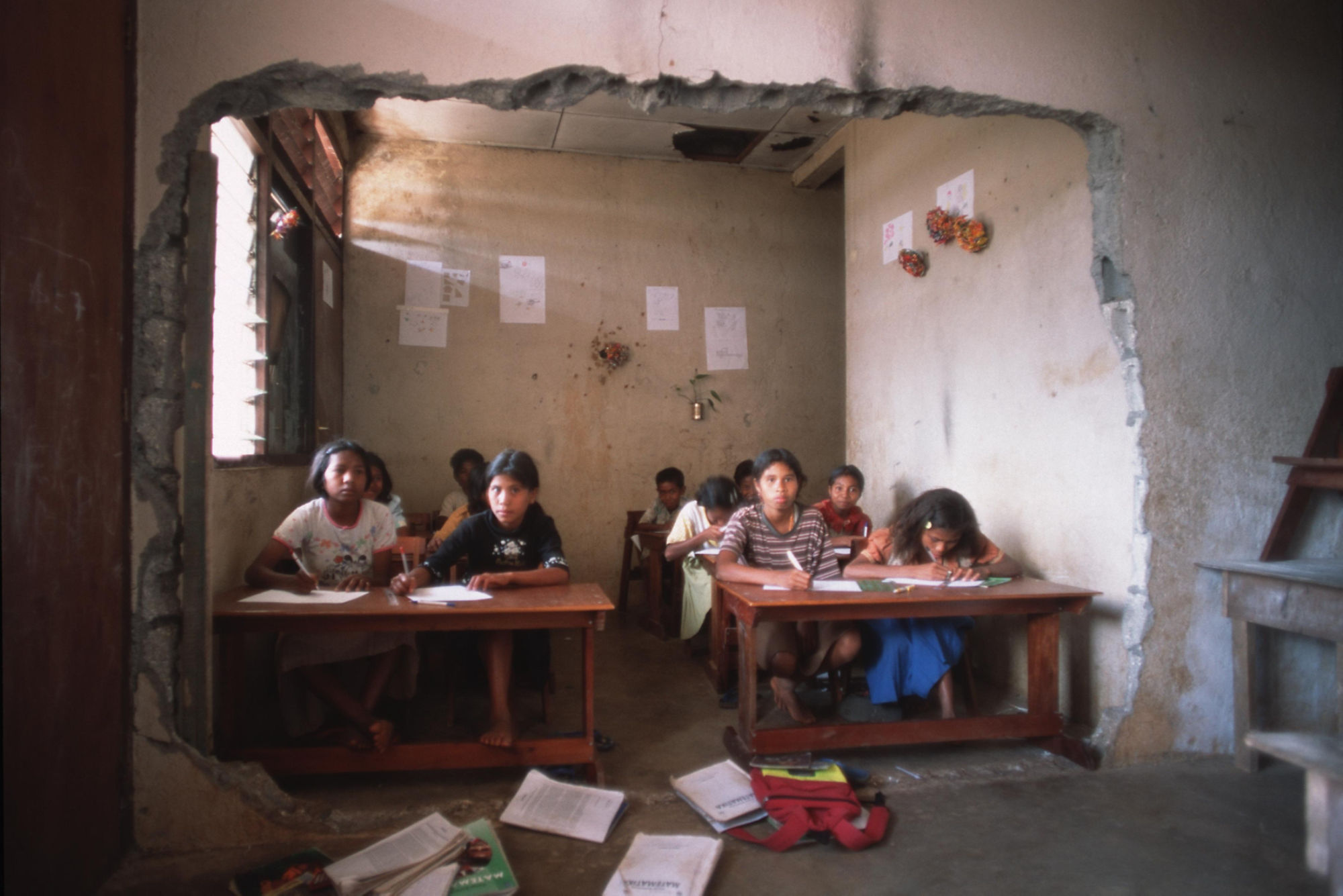 Girls in a war torn classroom