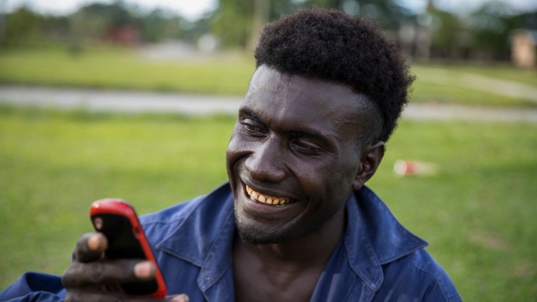 Man from Solomon Islands looking at his phone