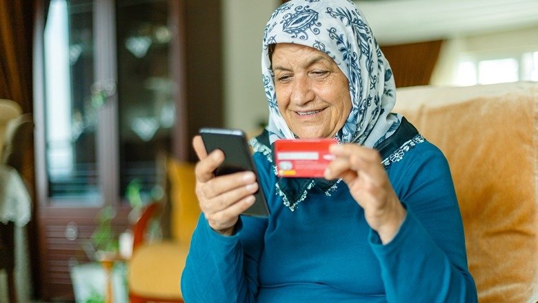 Woman using credit card with her smartphone