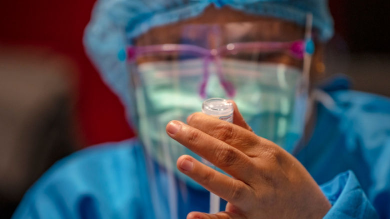 health worker prepares dose of vaccine at a mall theatre on September 16, 2021 in Bacoor, Cavite province, Philippines