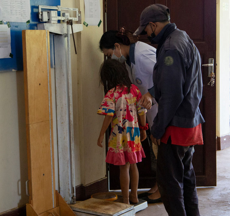 Gril being measured at hospital in Laos 