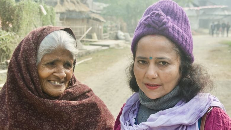 Kalpana Deo (right), with a beneficiary of social security allowance in Nepal