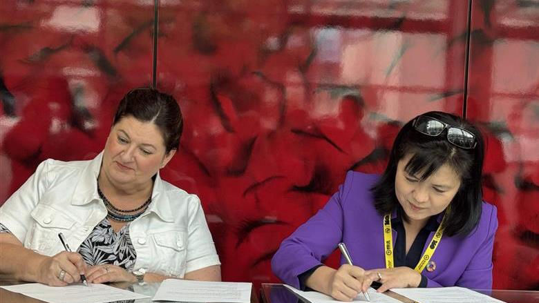 Amy Doherty, and Stephanie Hung, sign a letter of intent on geospatial content.