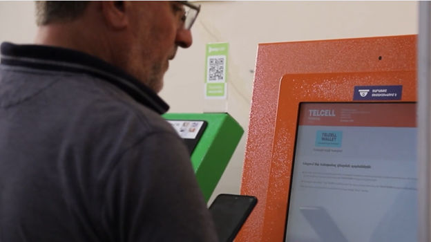 A customer uses a self-service terminal at Armenia's business registry office. 