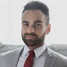 Young man in a suit with a bear