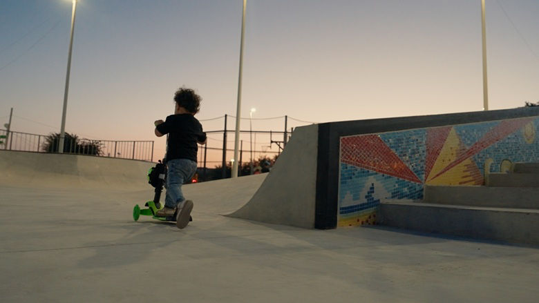 A child riding a scooter in a portion of the renovated Barekamutyun Park in Gyumri, Armenia