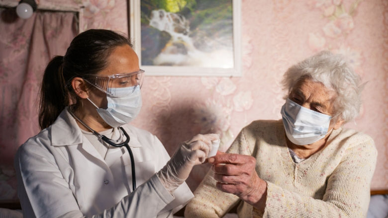 Doctor checks patient at home