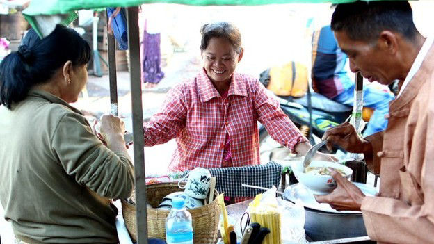 Noodle-maker provides breakfast outside the market in Hsipaw, central Myanmar. 
