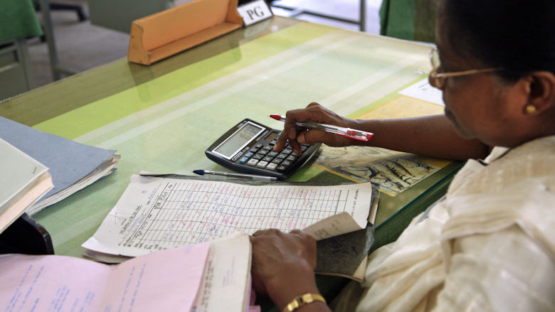 A woman with a calculator doing paperwork