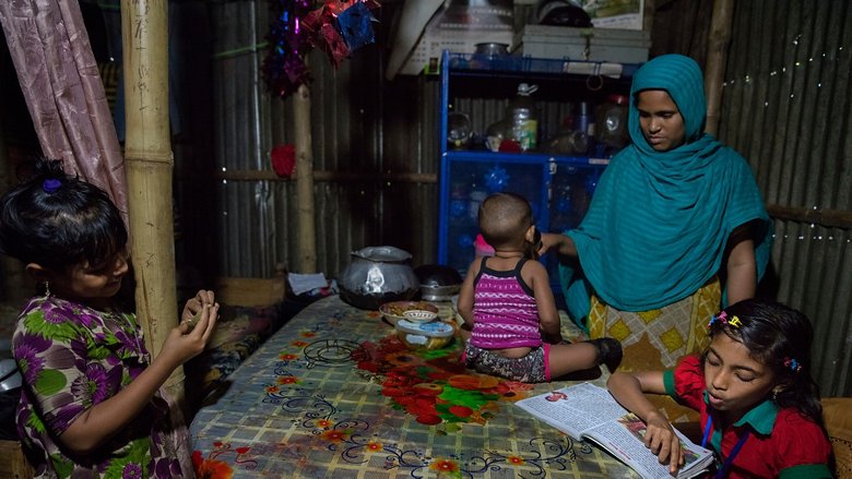 Sumaiya Nazma, 10 years old, reads at home in the Sujat Nagar slum in Dhaka, Bangladesh