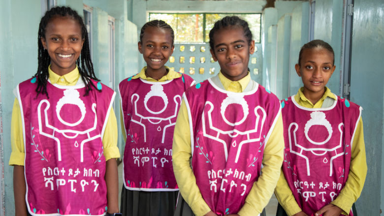Ethiopian school aged girls smiling after a WASH session
