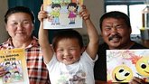 happy parents and their child from rural Mongolia