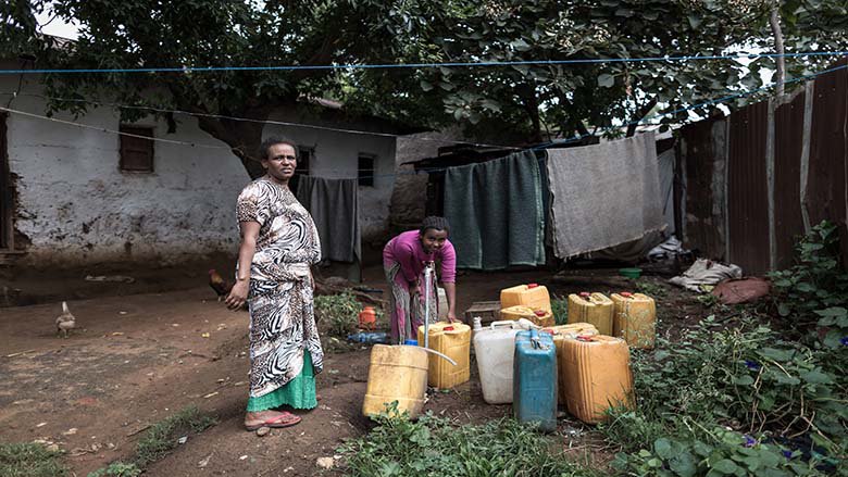 An image of women collecting water at a tap in Ethiopia