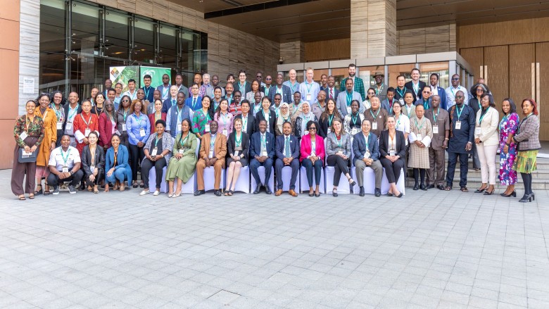 GWP 2025 annual conference attendees pose outside in front of building.