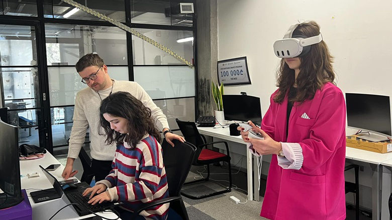 Theneo employees testing out a VR headset