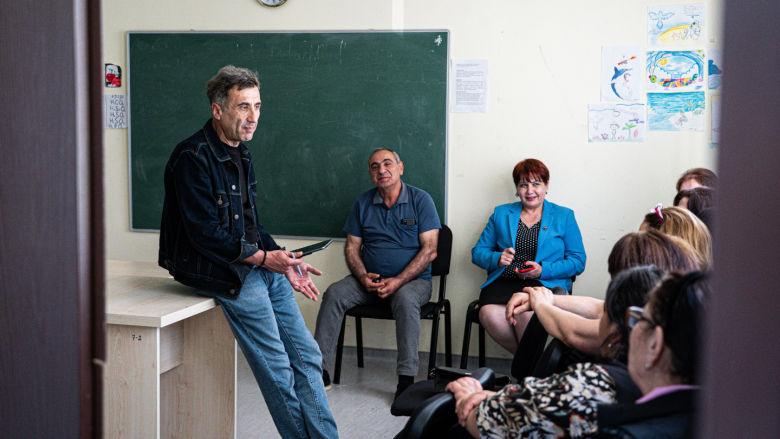 Mindia Salukvadze, a trainer through DAP, talks to locals about how to navigate the web safely and avoid scams. 