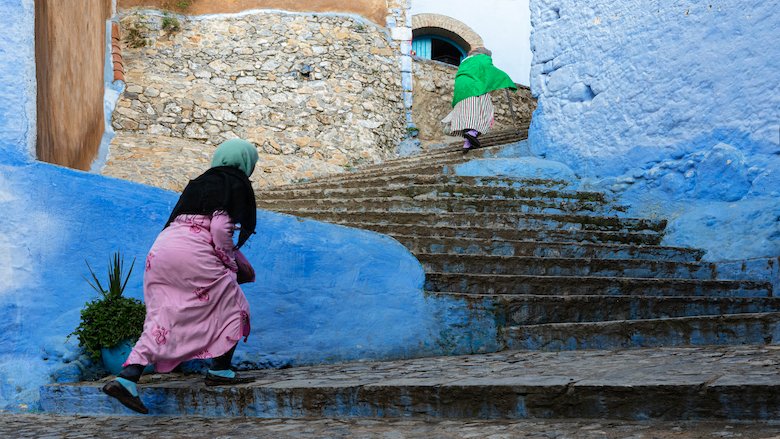 Women walking up Steps in the Medina of Chefchaouen, Morocco