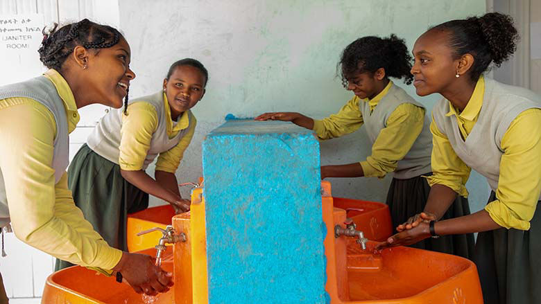 An image of girls washing their hands