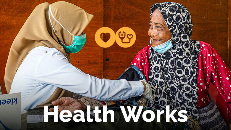 Health Works: a elderly woman's blood pressure is taken in a rural clinic