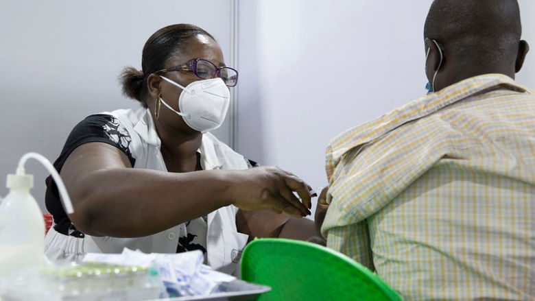 Healthcare worker prepares COVID-19 vaccination for a patient