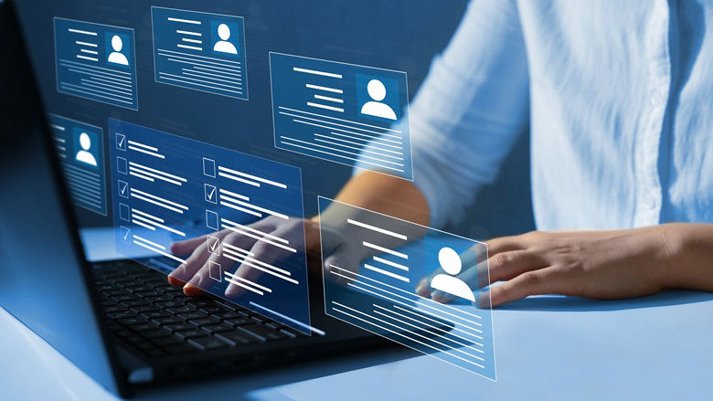 A person using a laptop displaying profile icons