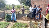 group of women showing their crops