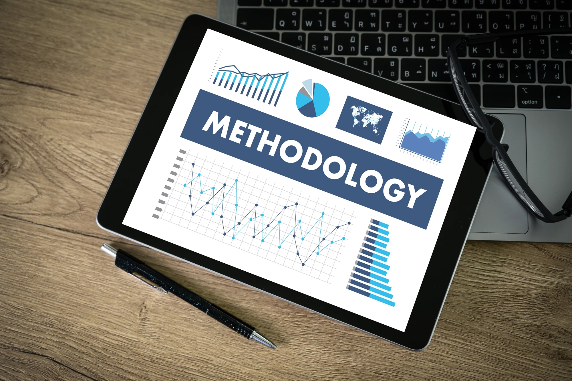 METHODOLOGY CONTEPT Business team hands at work with financial reports and a laptop