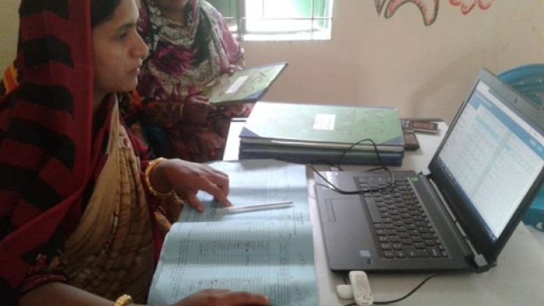 Bangladesh woman entering data in loan management system