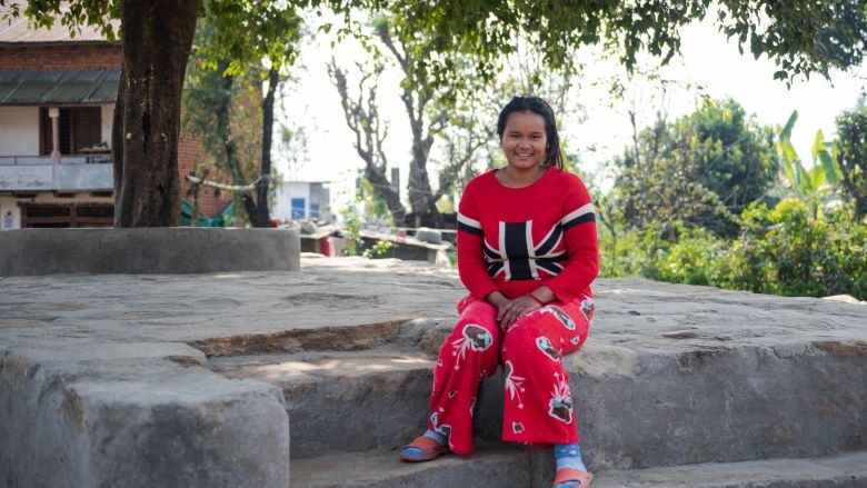 A woman from Nepal sits on a chautari