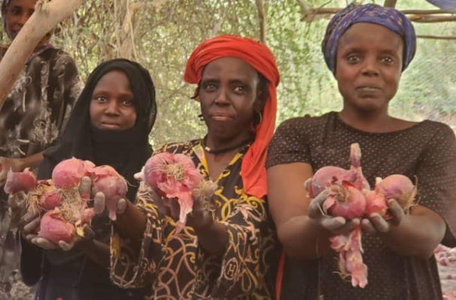 PROLAC beneficiaries showing their bountiful harvest to the camera.