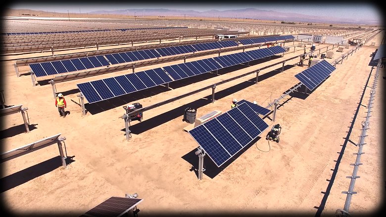 Aerial view of a large solar plant in an arid terrain 