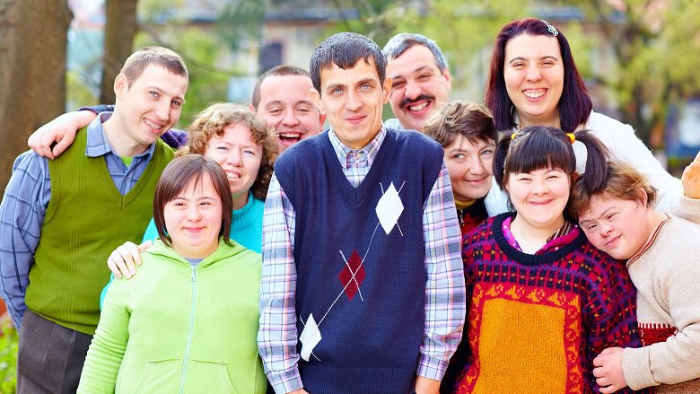 A group of individuals with disabilities pose for a photo