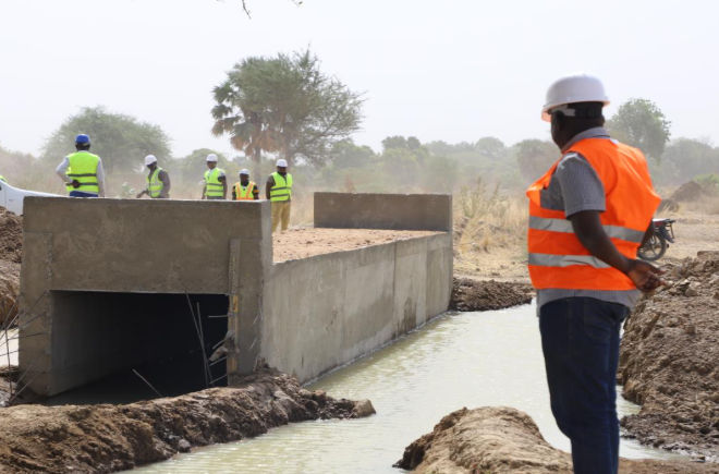 Construction workers rehabilitate the roads after 2024 floods in Cameroon.