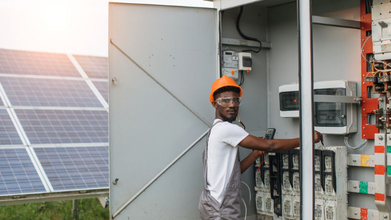 An African engineer checks a data center fueled by solar energy