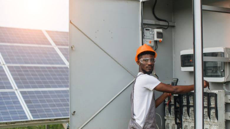 An African engineer checks a data center fueled by solar energy