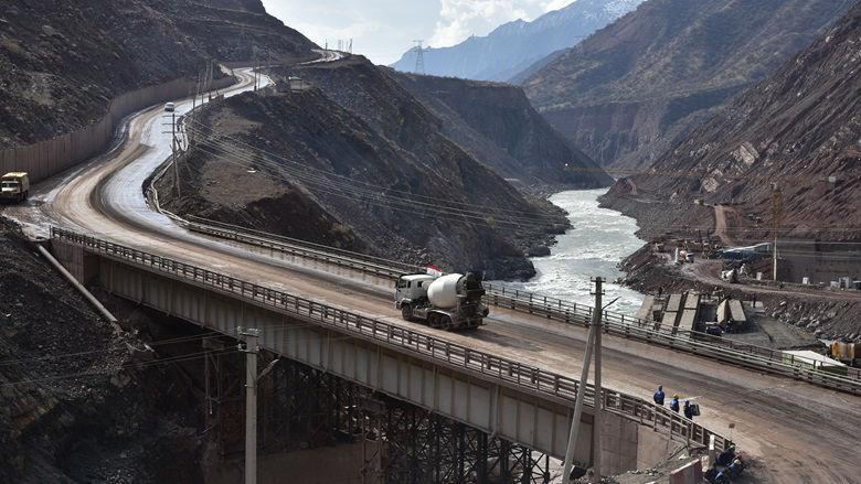 A cement truck drives over a bridge near the Rogun HPP construction site