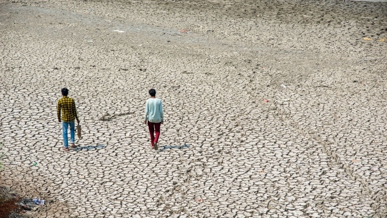overhead view of two people walking in drought effected area.