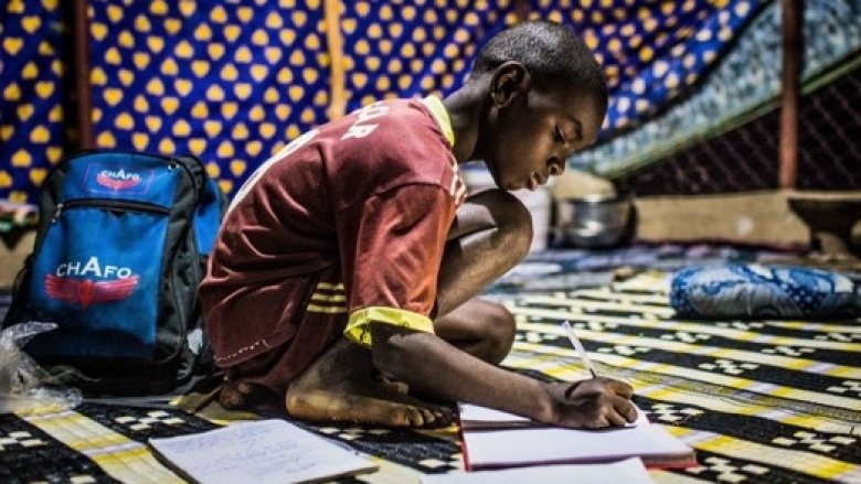 Sebani Gueye, 10, does homework at home in a village in Senegal. His family just got electricity and he finally doesn't have to study in candle light. Photo: © Vincent Tremeau/World Bank