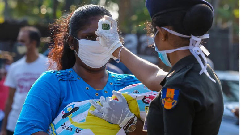 a woman getting her temperature measured 