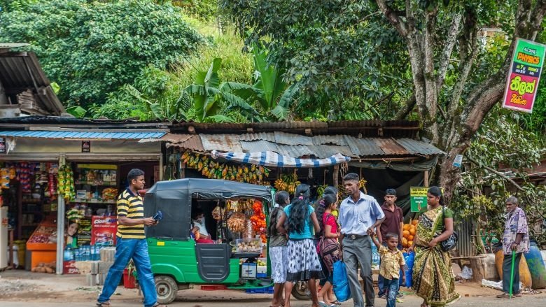 People in front of roadside shops in Sri Lanka
