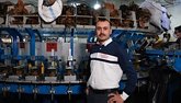 Ahmad Ksheish, a Syrian refugee, stands proudly in his shoemaking factory for which he received equipment, software, and pers