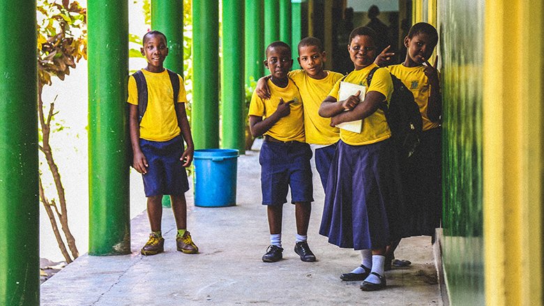 Students in uniform stand together in an outdoor corridor of their school in Dar es Salaam, Tanzania