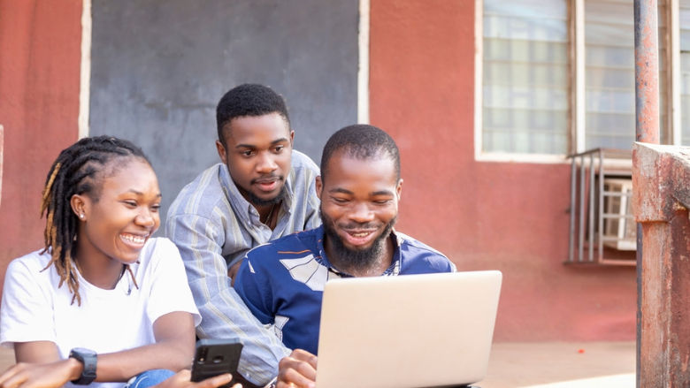 Group of young Africa using laptop and mobile phones to work on projects