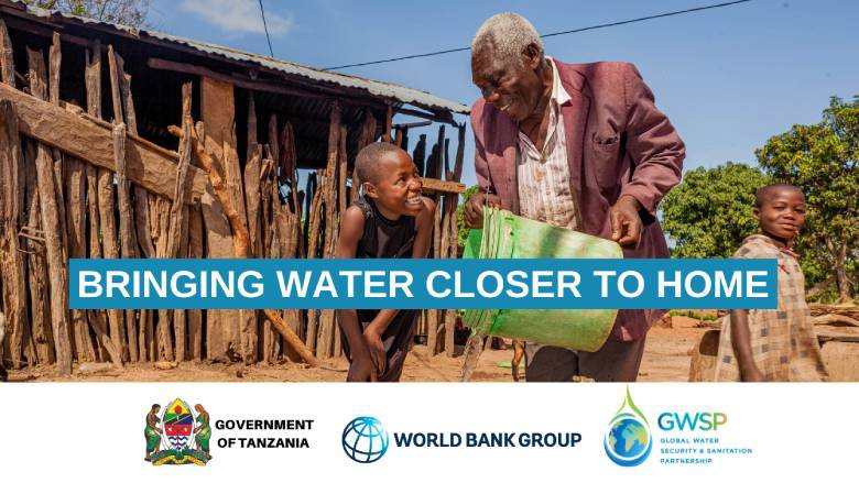 A man in rural Tanzania pours water into a bucketk for a child.