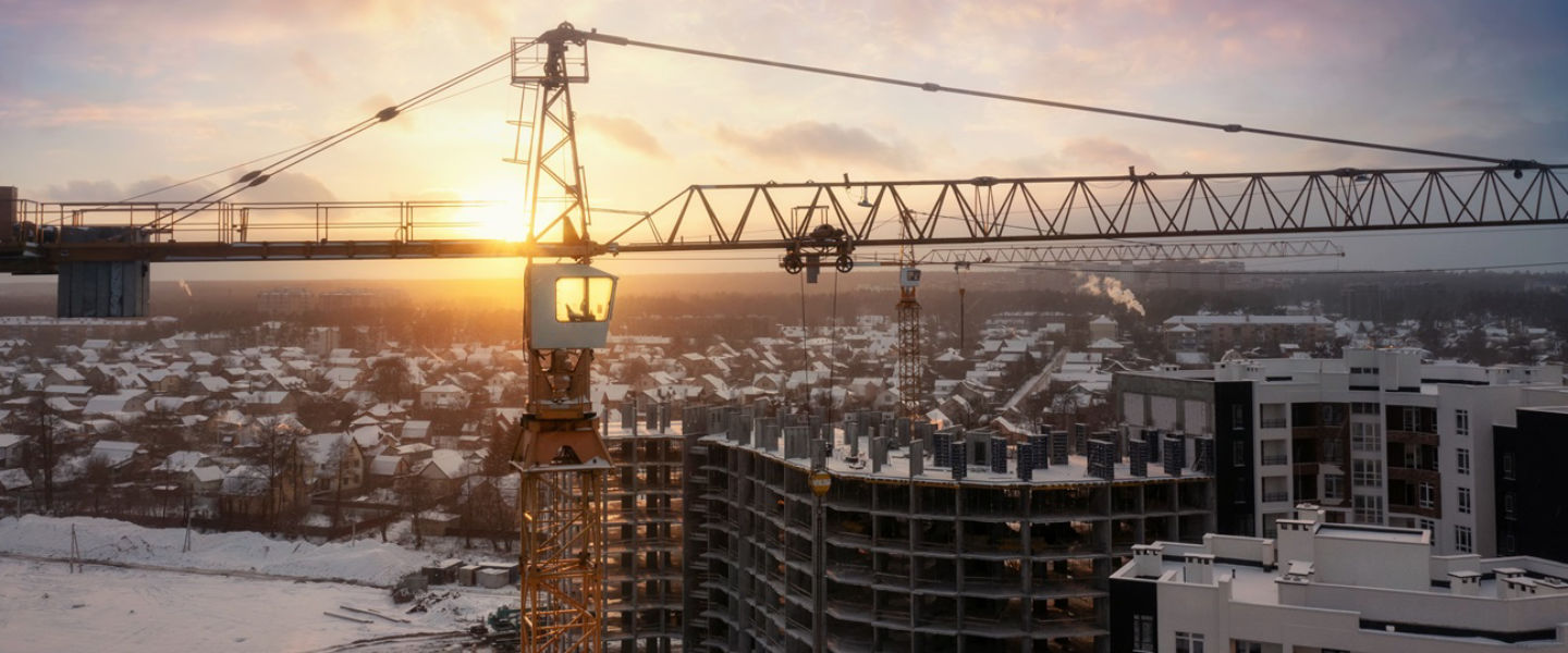 Industrial crane stands over a construction site on a winter's day in Ukraine