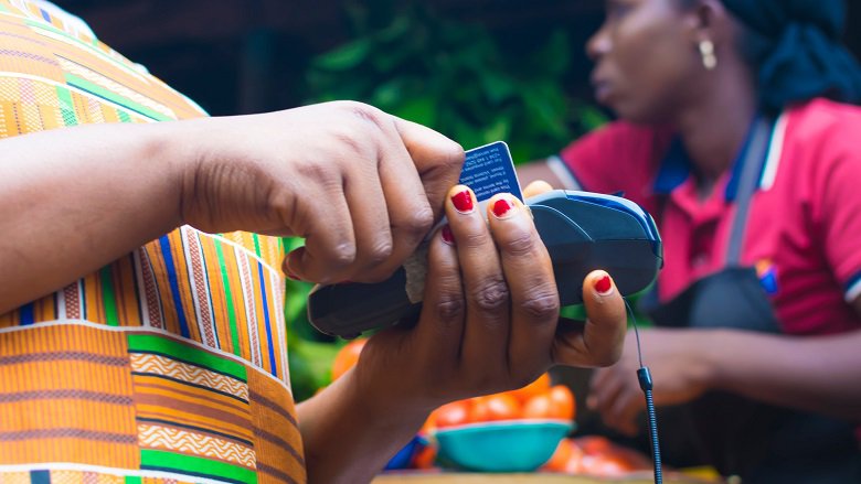 African shopping in the market using credit card
