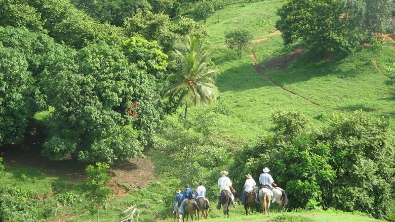 Costa Rica landscape and people on the horses 