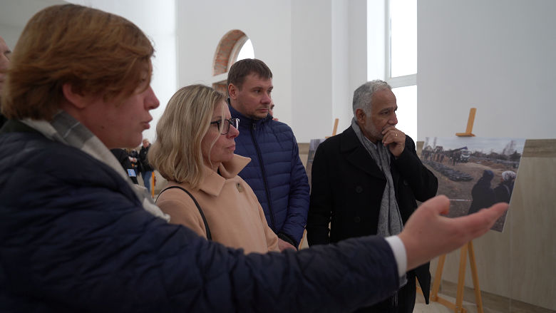 The World Bank delegation views a photo exhibit of the destruction of Bucha.